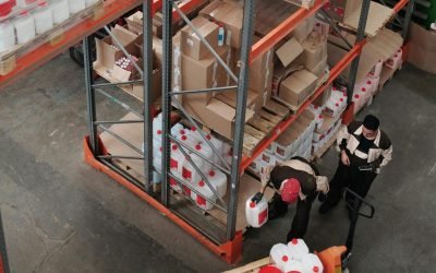 Warehouse workers organizing inventory on shelves, enhancing logistics efficiency.