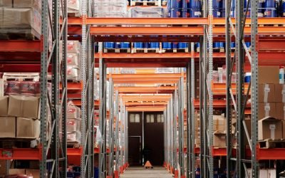 A modern warehouse interior showcasing organized shelves and pallets for efficient storage.